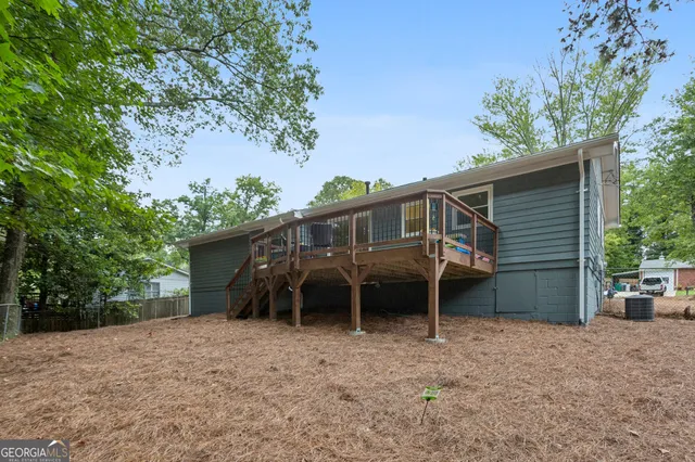 front view of a house with a yard and a large tree