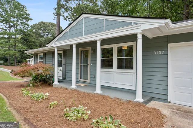 a house with trees in the background