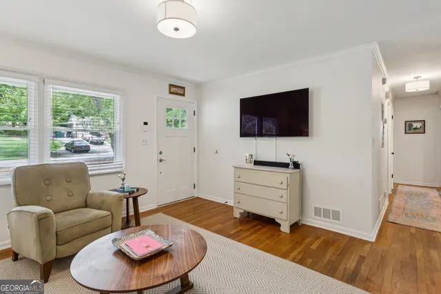 a living room with furniture and a flat screen tv