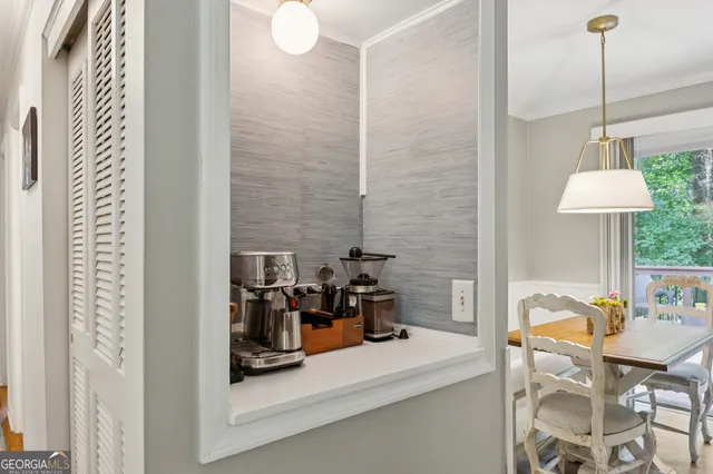a dining room with furniture and a chandelier