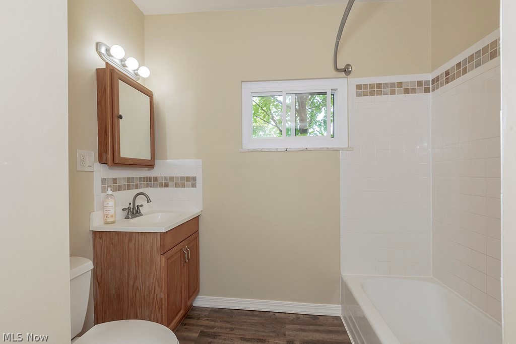 3090 Warren Road Cleveland, OH 44111 - Photo 32 of 50 Full bathroom featuring vanity, tiled shower / bath combo, toilet, and wood-type flooring