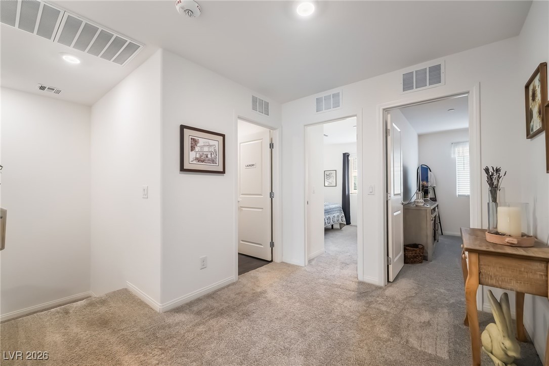 12235 Glass Desert Road, Unit 2 Las Vegas, NV 89183 - Photo 12 of 33 Hall featuring light carpet and recessed lighting