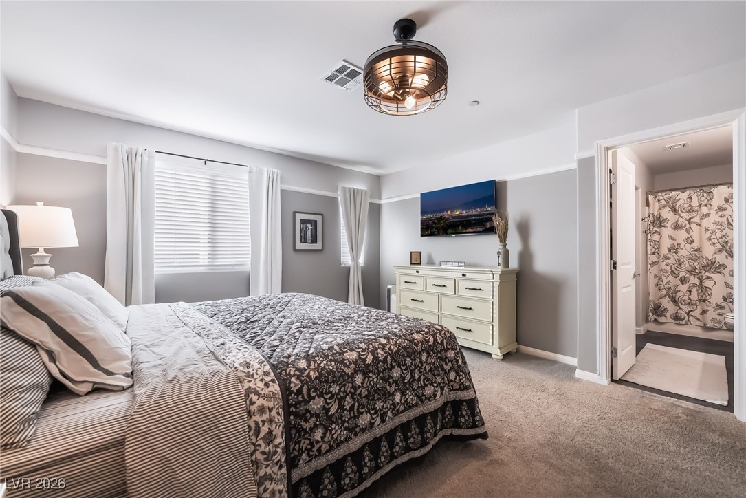 12235 Glass Desert Road, Unit 2 Las Vegas, NV 89183 - Photo 16 of 33 Bedroom featuring light carpet and connected bathroom