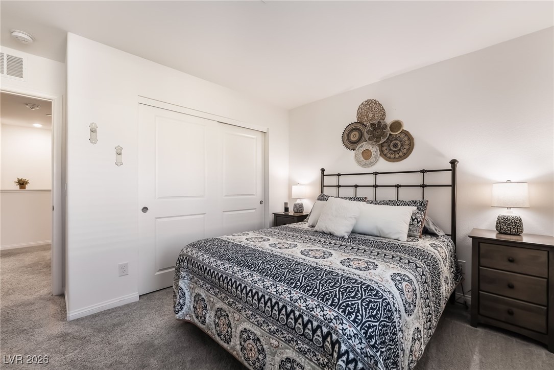 12235 Glass Desert Road, Unit 2 Las Vegas, NV 89183 - Photo 21 of 33 Carpeted bedroom with baseboards and a closet