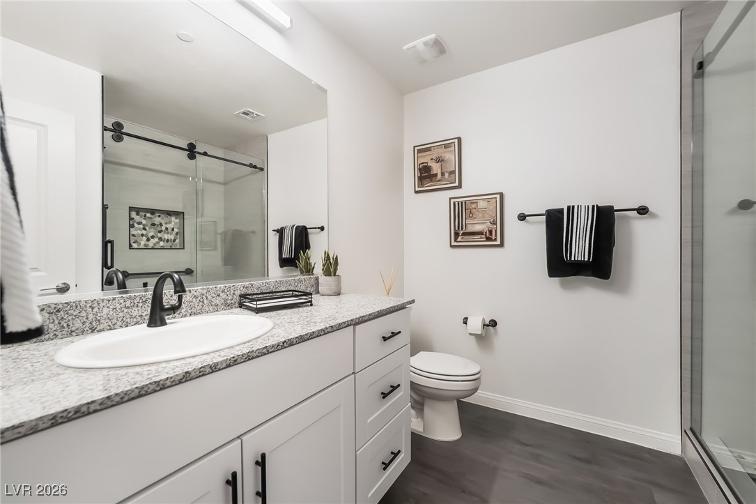 12235 Glass Desert Road, Unit 2 Las Vegas, NV 89183 - Photo 22 of 33 Bathroom featuring vanity and a stall shower