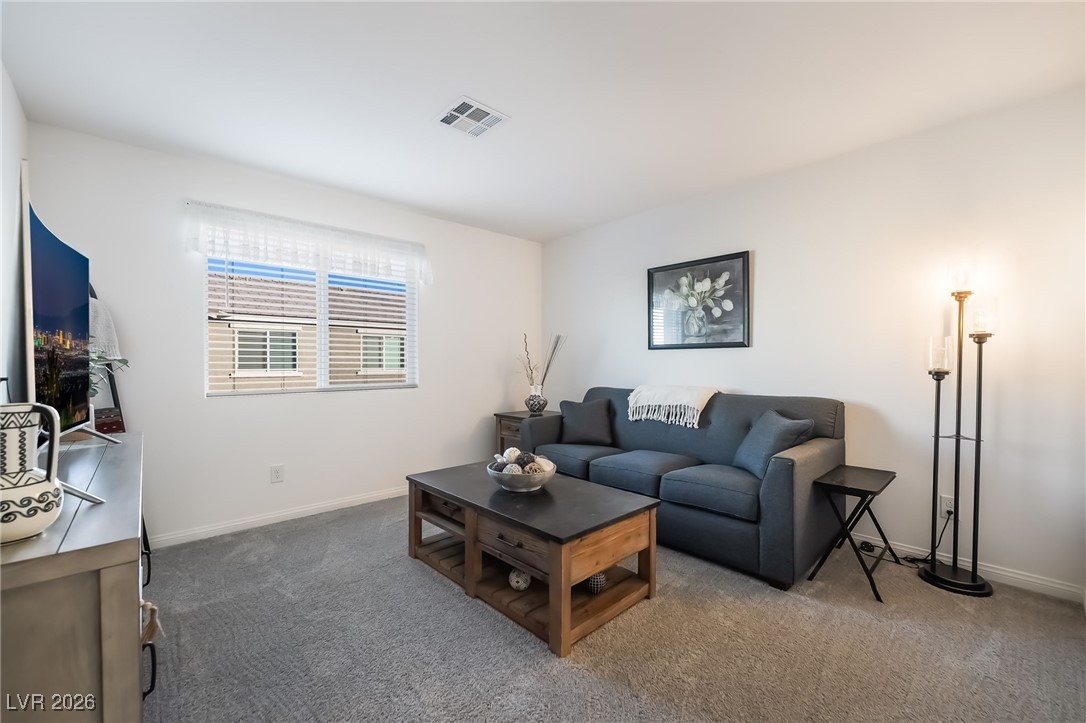 12235 Glass Desert Road, Unit 2 Las Vegas, NV 89183 - Photo 24 of 33 Living area with carpet flooring and baseboards