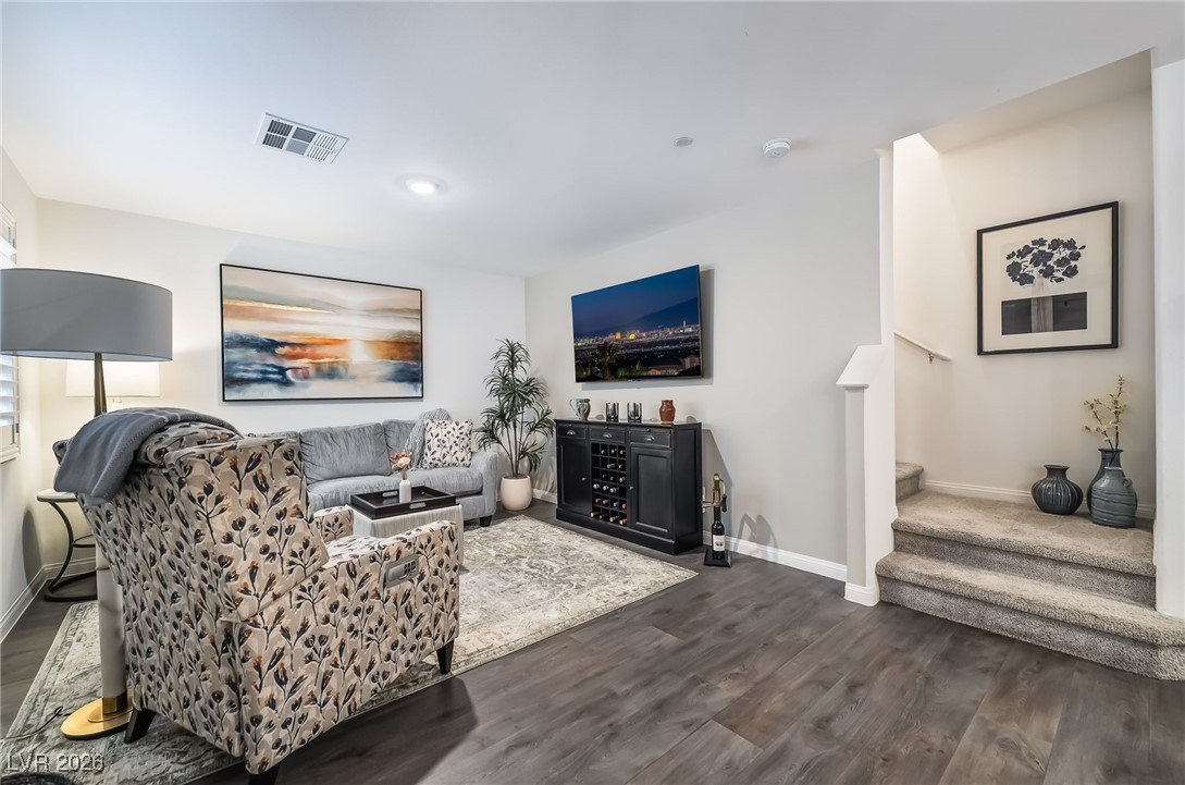 12235 Glass Desert Road, Unit 2 Las Vegas, NV 89183 - Photo 6 of 33 Living area with stairway and dark wood-style flooring