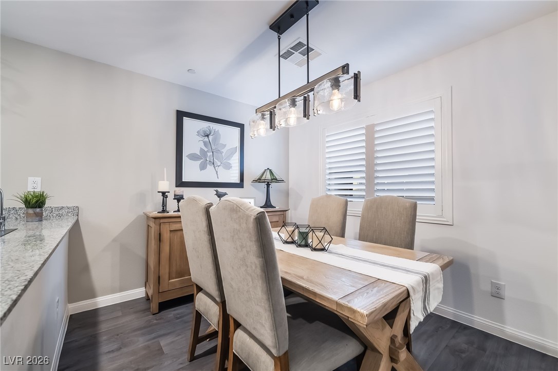 12235 Glass Desert Road, Unit 2 Las Vegas, NV 89183 - Photo 8 of 33 Dining room featuring dark wood finished floors and baseboards