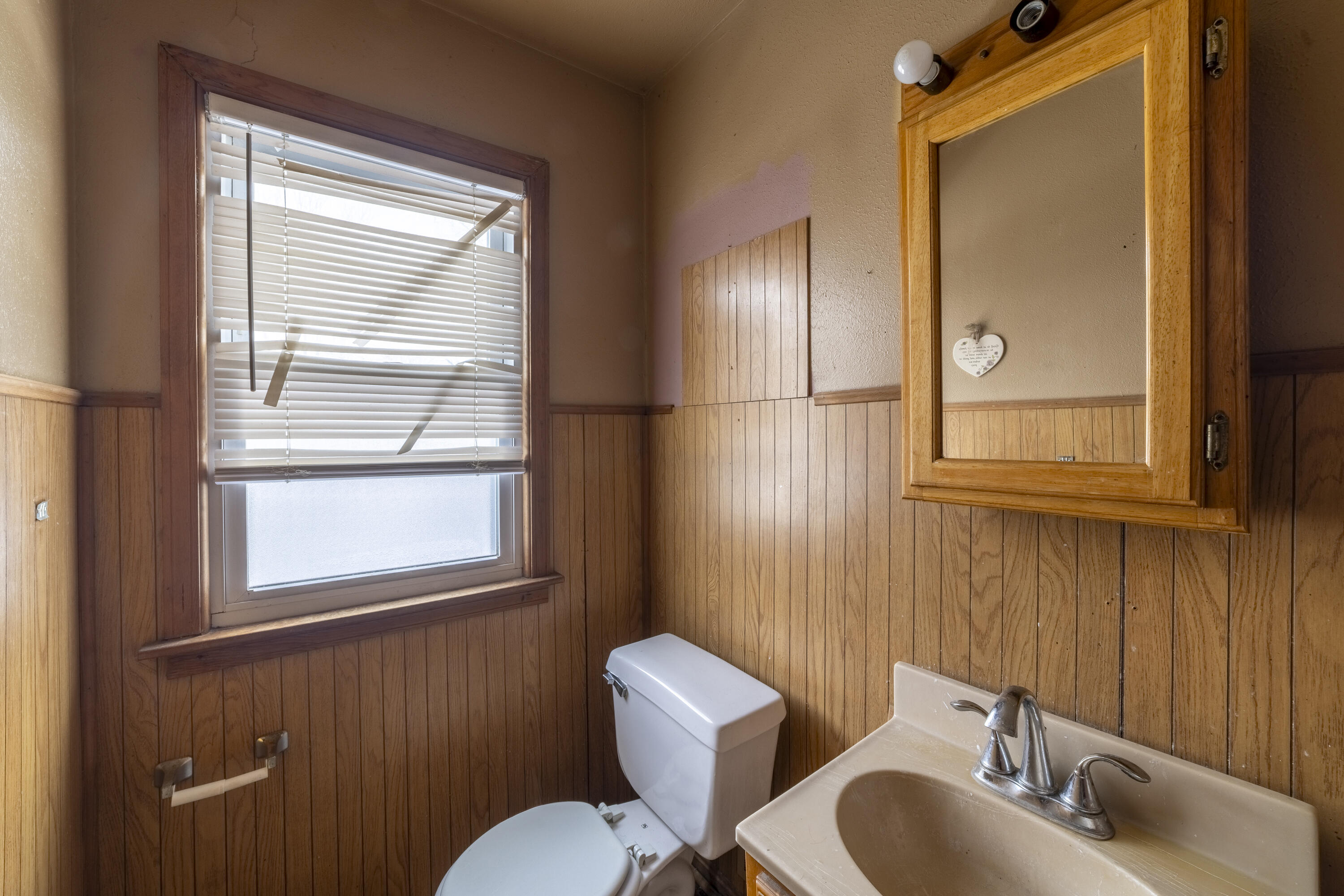 132 Hendricks Street Michigan City, IN 46360 - Photo 14 of 21 a bathroom with a toilet sink vanity and mirror