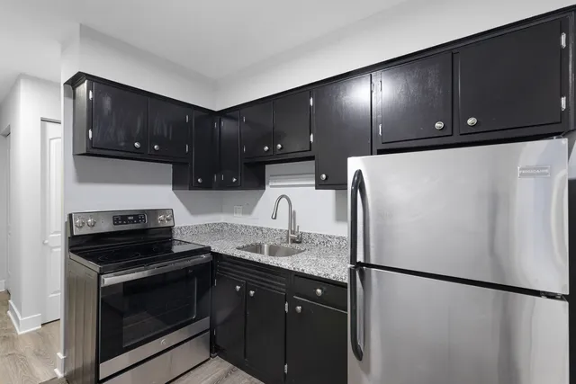 a kitchen with a refrigerator and a sink