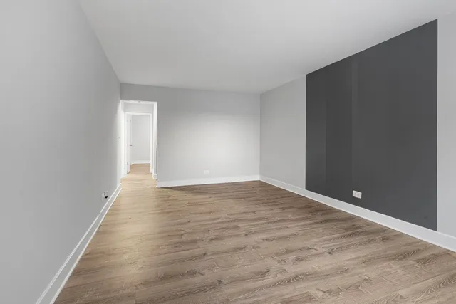 a view of an empty room and wooden floor