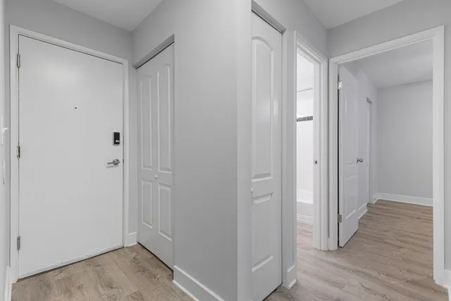 a view of a hallway with wooden floor