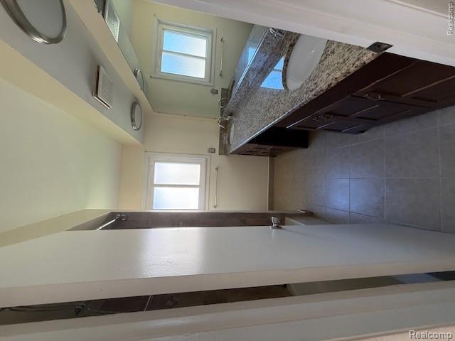 43038 Hanford Road Canton, MI 48187 - Photo 25 of 36 Bathroom featuring a long dual vanity with a granite-style countertop and integrated sinks, a large wall-mounted mirror, and tile flooring