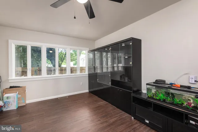 a view of a large room with wooden floor and windows