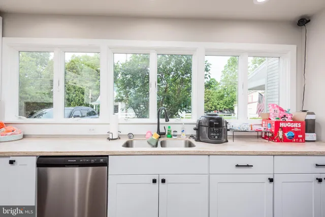 a kitchen with a large window and sink