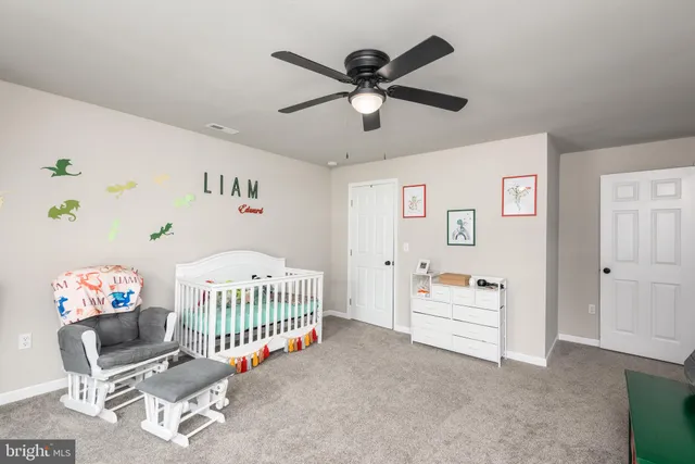 a bedroom with furniture and a chandelier fan