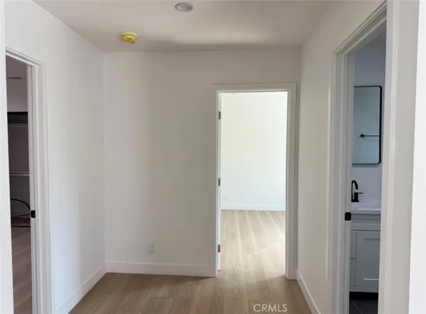 an empty room with wooden floor and closet