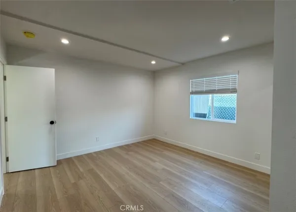 a view of a kitchen with a sink and a refrigerator