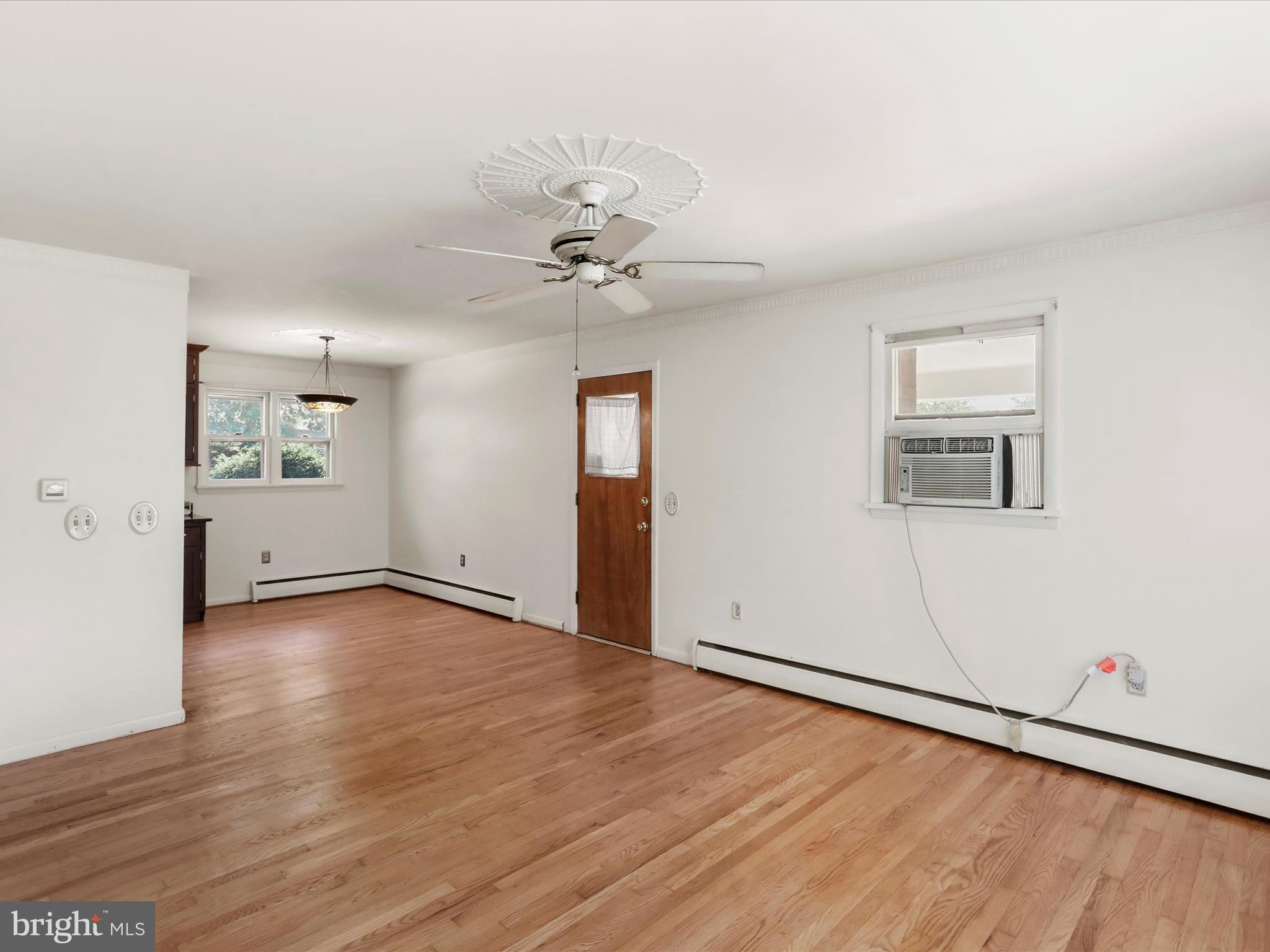 810 Winifred Road Cumberland, MD 21502 - Photo 12 of 45 an empty room with wooden floor and windows