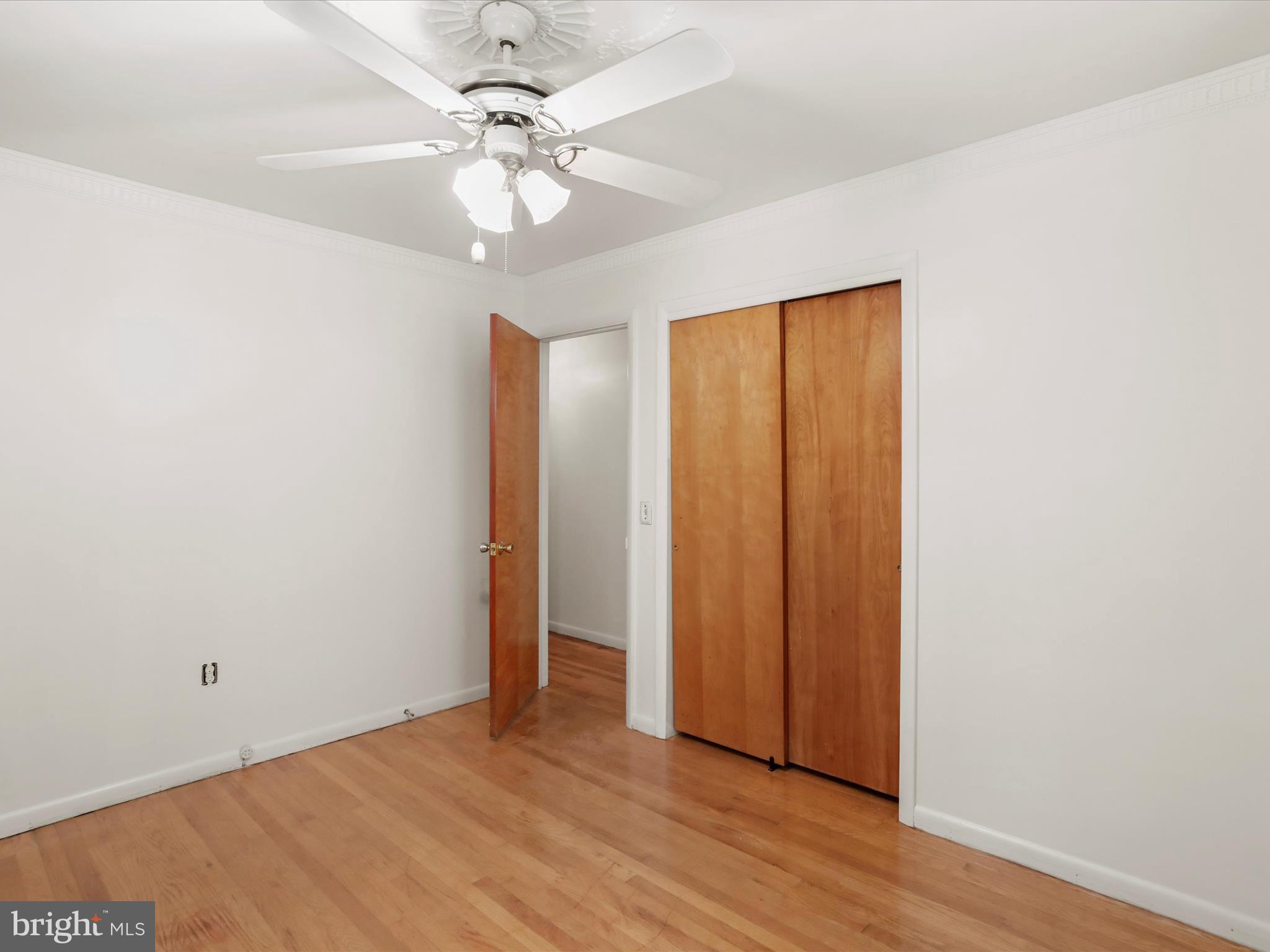 810 Winifred Road Cumberland, MD 21502 - Photo 16 of 45 an empty room with wooden floor and fan chandelier