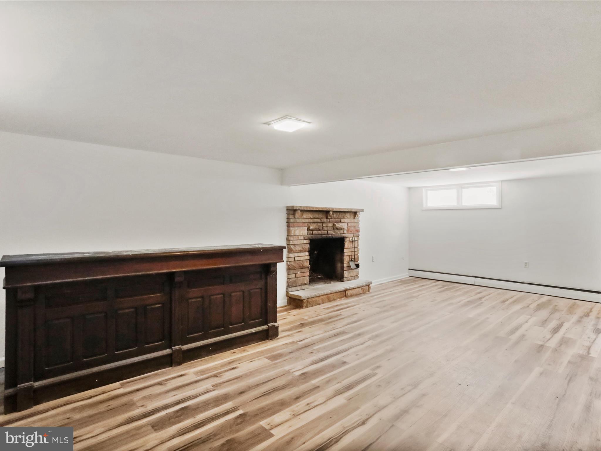 810 Winifred Road Cumberland, MD 21502 - Photo 23 of 45 a view of an empty room with wooden floor and a fireplace