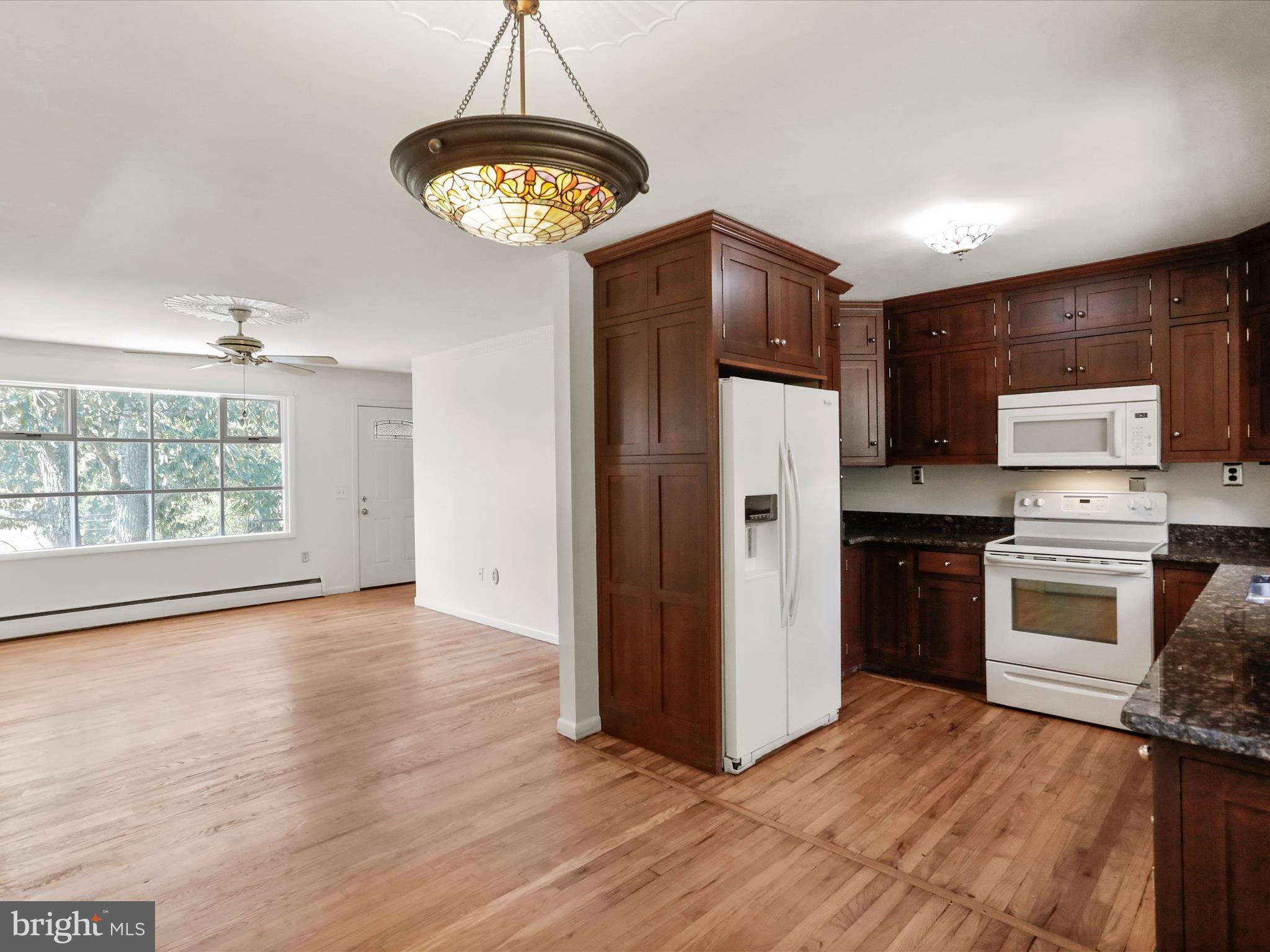 810 Winifred Road Cumberland, MD 21502 - Photo 3 of 45 a kitchen with stainless steel appliances granite countertop a refrigerator a stove a sink dishwasher and a refrigerator with wooden floor