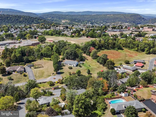 an aerial view of residential house and sandy dunes