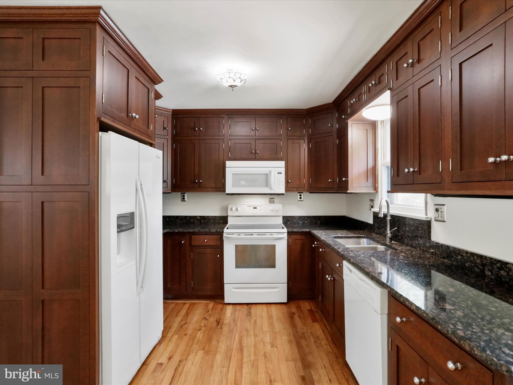 810 Winifred Road Cumberland, MD 21502 - Photo 6 of 45 a kitchen with granite countertop stainless steel appliances a refrigerator cabinets and wooden floor