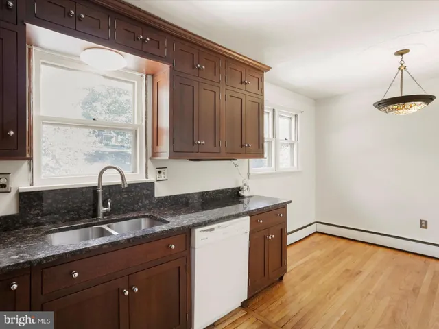 a kitchen with granite countertop a sink and cabinets