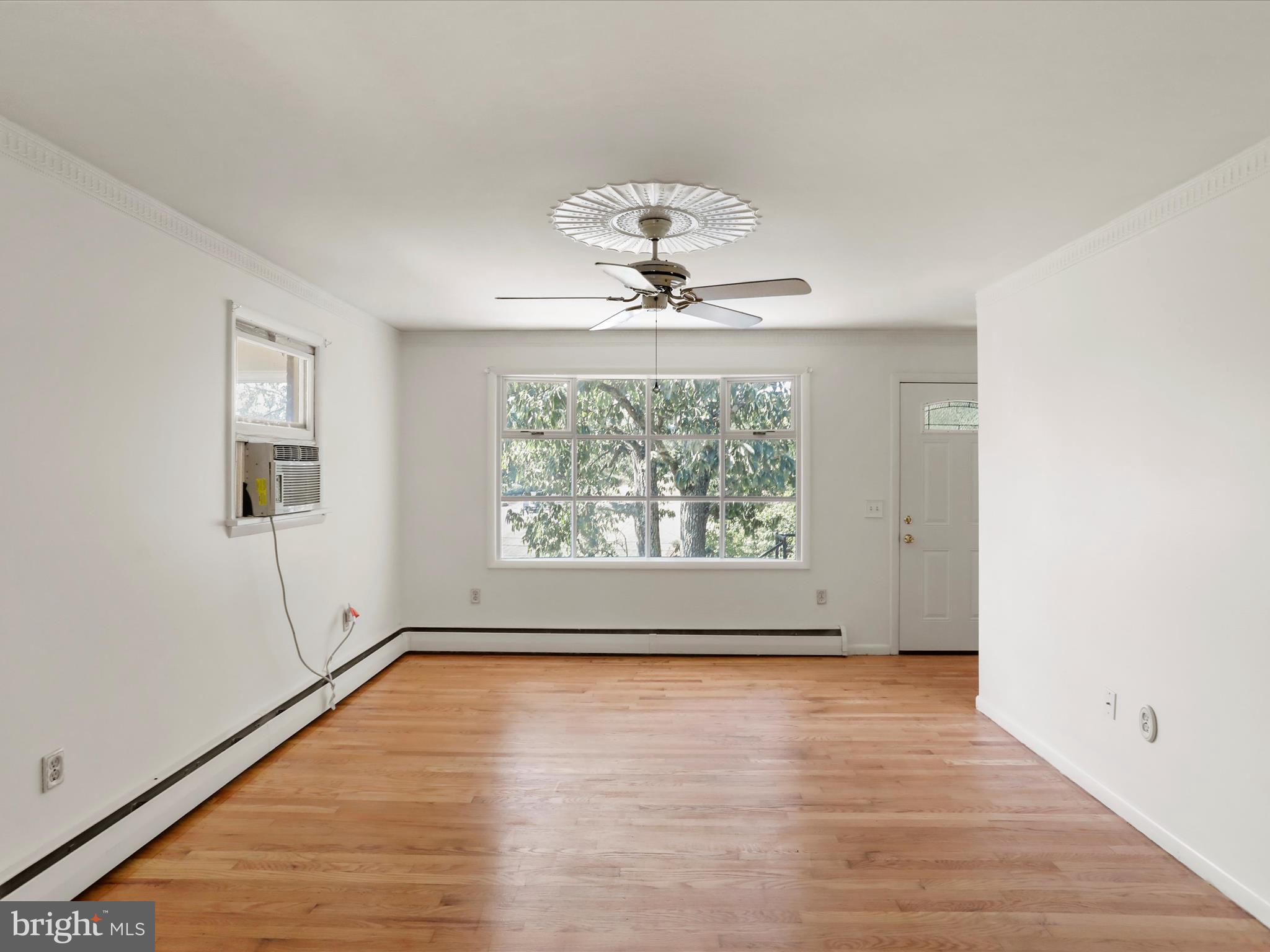 810 Winifred Road Cumberland, MD 21502 - Photo 9 of 45 an empty room with wooden floor chandelier and windows