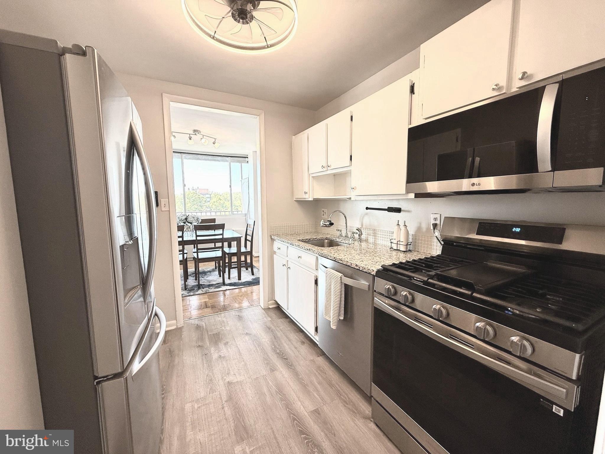 4343 Cherry Hill Road, Unit 705 Arlington, VA 22207 - Photo 3 of 38 a kitchen with stainless steel appliances a stove microwave and a refrigerator