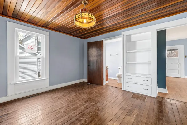 wooden floor in an empty room with a window