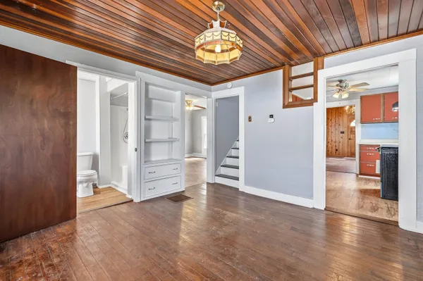 a view of a hallway with wooden floor