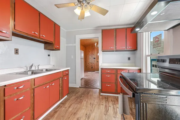 a kitchen with stainless steel appliances granite countertop a sink stove and cabinets