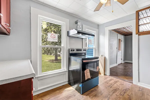 a kitchen view with wooden floor and a refrigerator