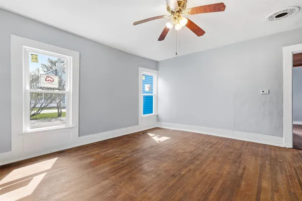 wooden floor in an empty room with a window