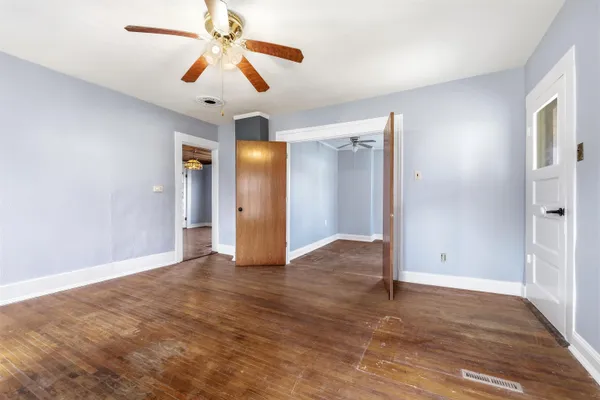 a view of an empty room with a ceiling fan