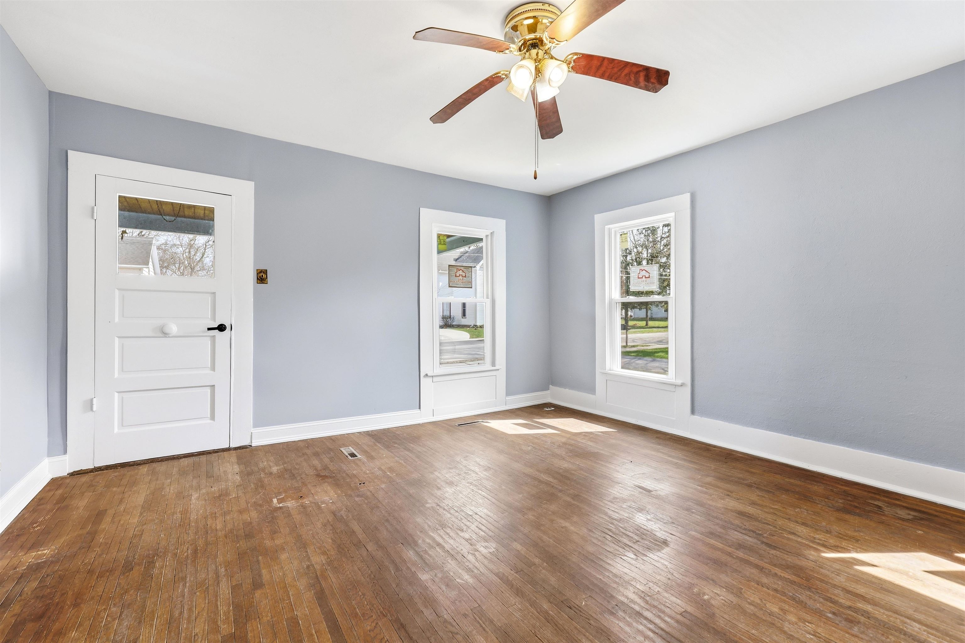 409 South Water Street Warren, IL 61087 - Photo 6 of 29 a view of an empty room with a window and wooden floor