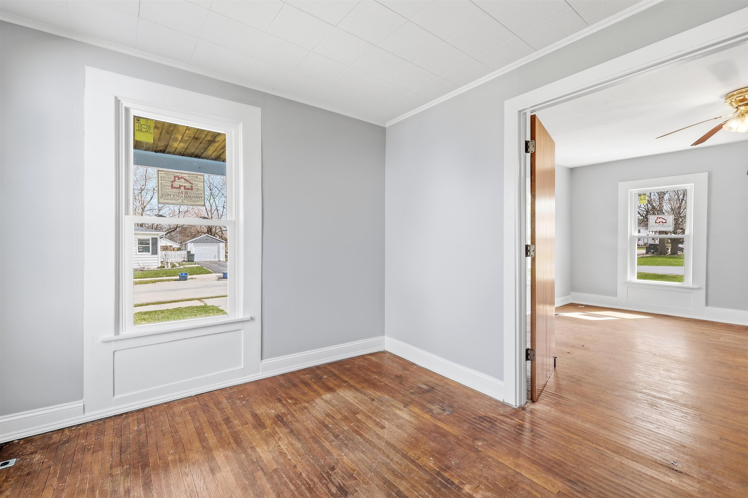409 South Water Street Warren, IL 61087 - Photo 8 of 29 a view of an empty room with window and wooden floor
