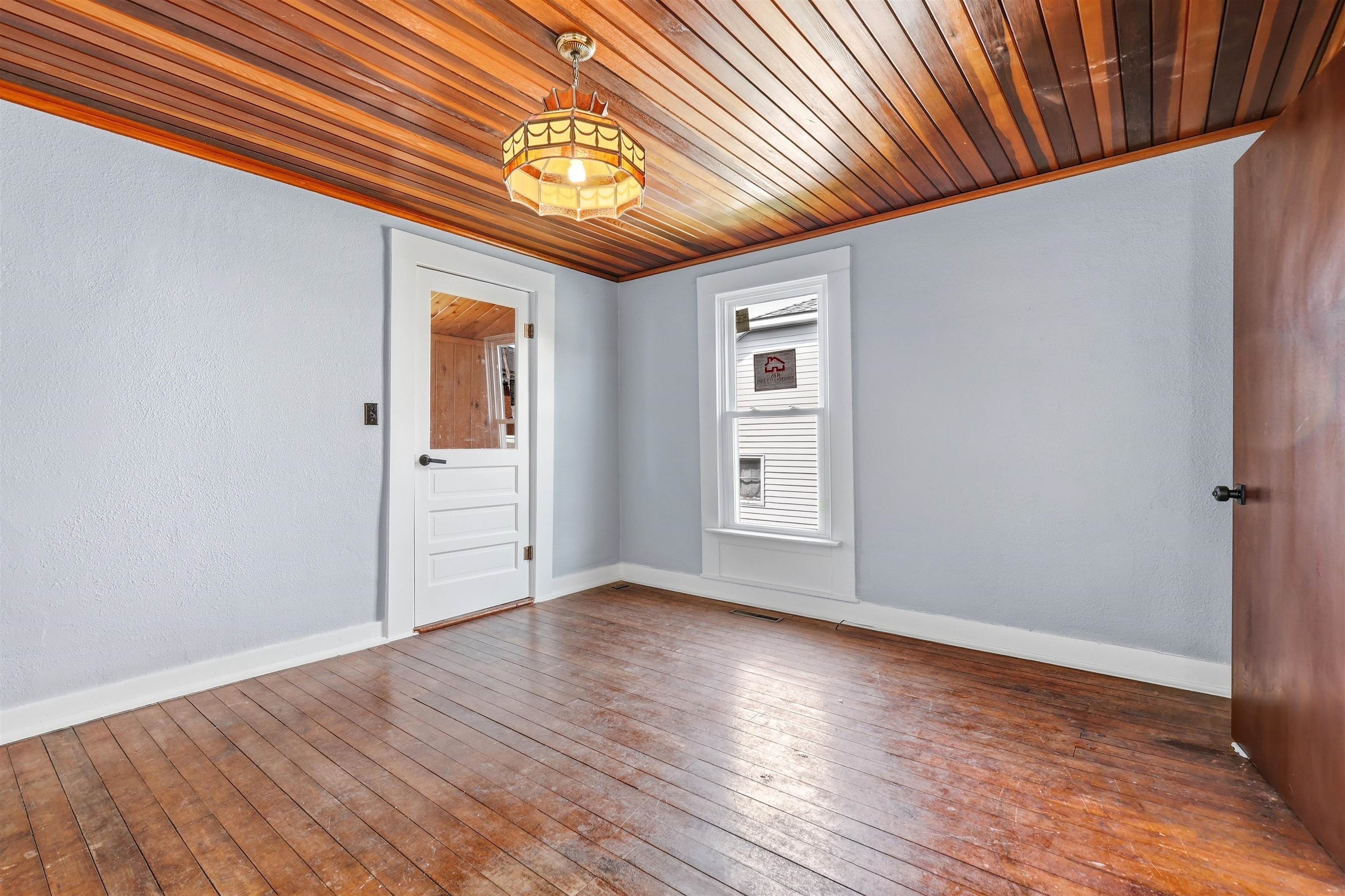409 South Water Street Warren, IL 61087 - Photo 10 of 29 a view of an empty room with wooden floor and a window