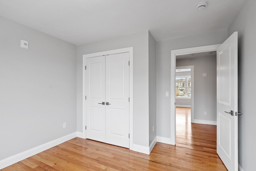 10 Windsor Street Worcester, MA 01605 - Photo 18 of 26 wooden floor & wooden door in an empty room