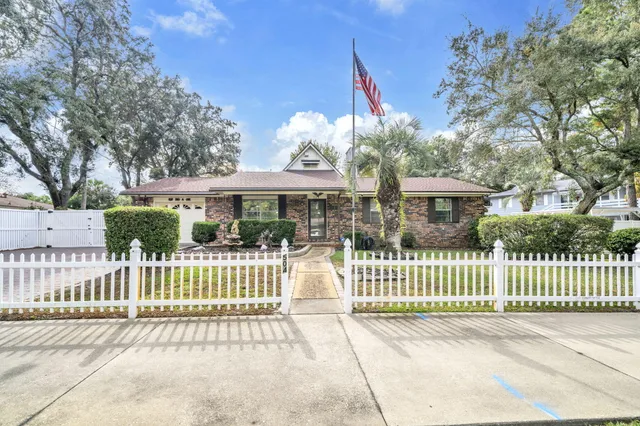 a view of a house with backyard and sitting area