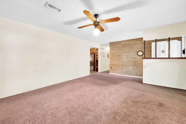 a dining room with furniture a flat screen tv and a large window