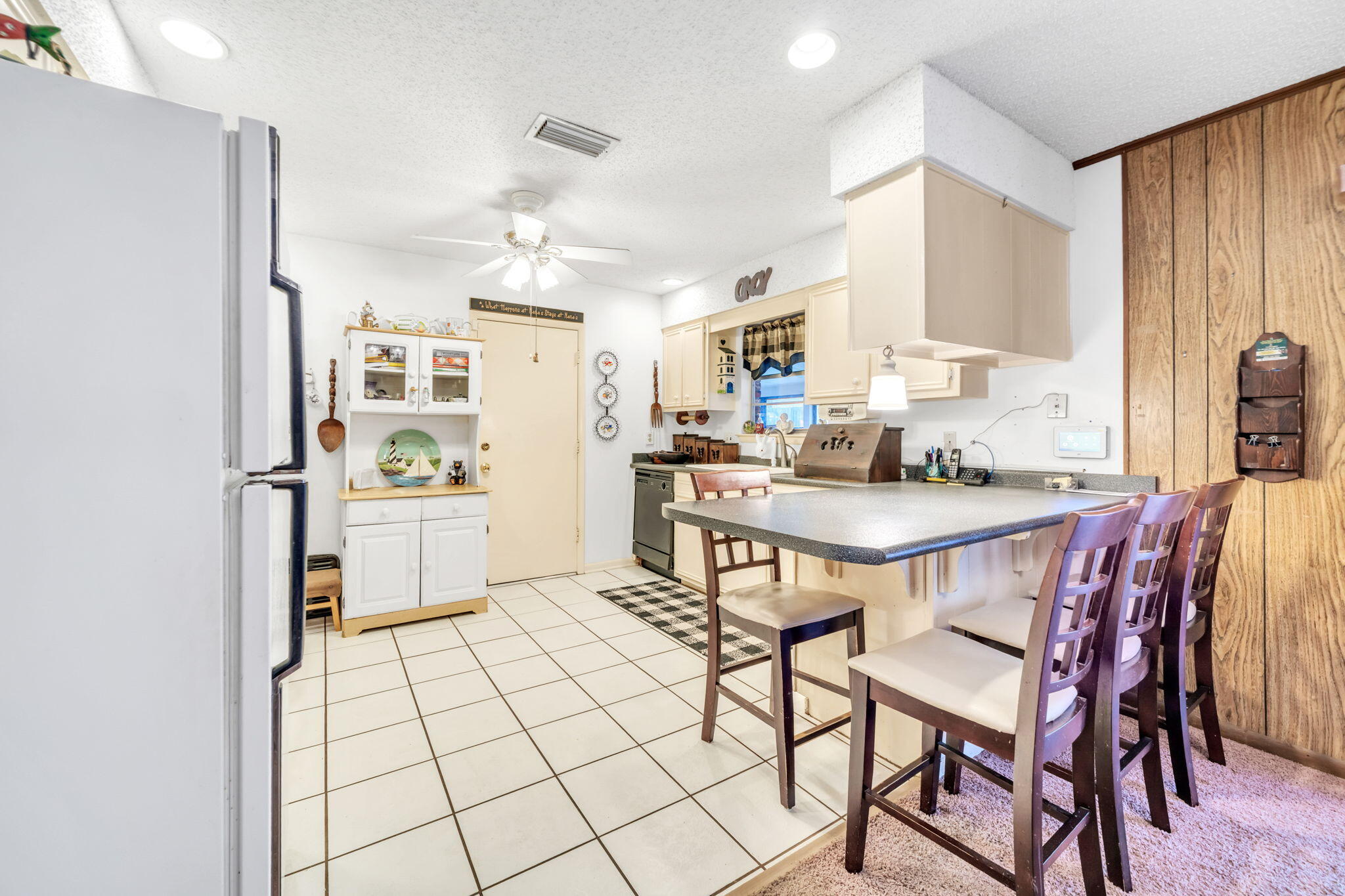 504 Kelly Street Destin, FL 32541 - Photo 13 of 92 a kitchen with stainless steel appliances kitchen island granite countertop a sink cabinets and refrigerator
