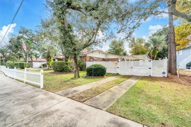 a view of a house with a backyard and a garage