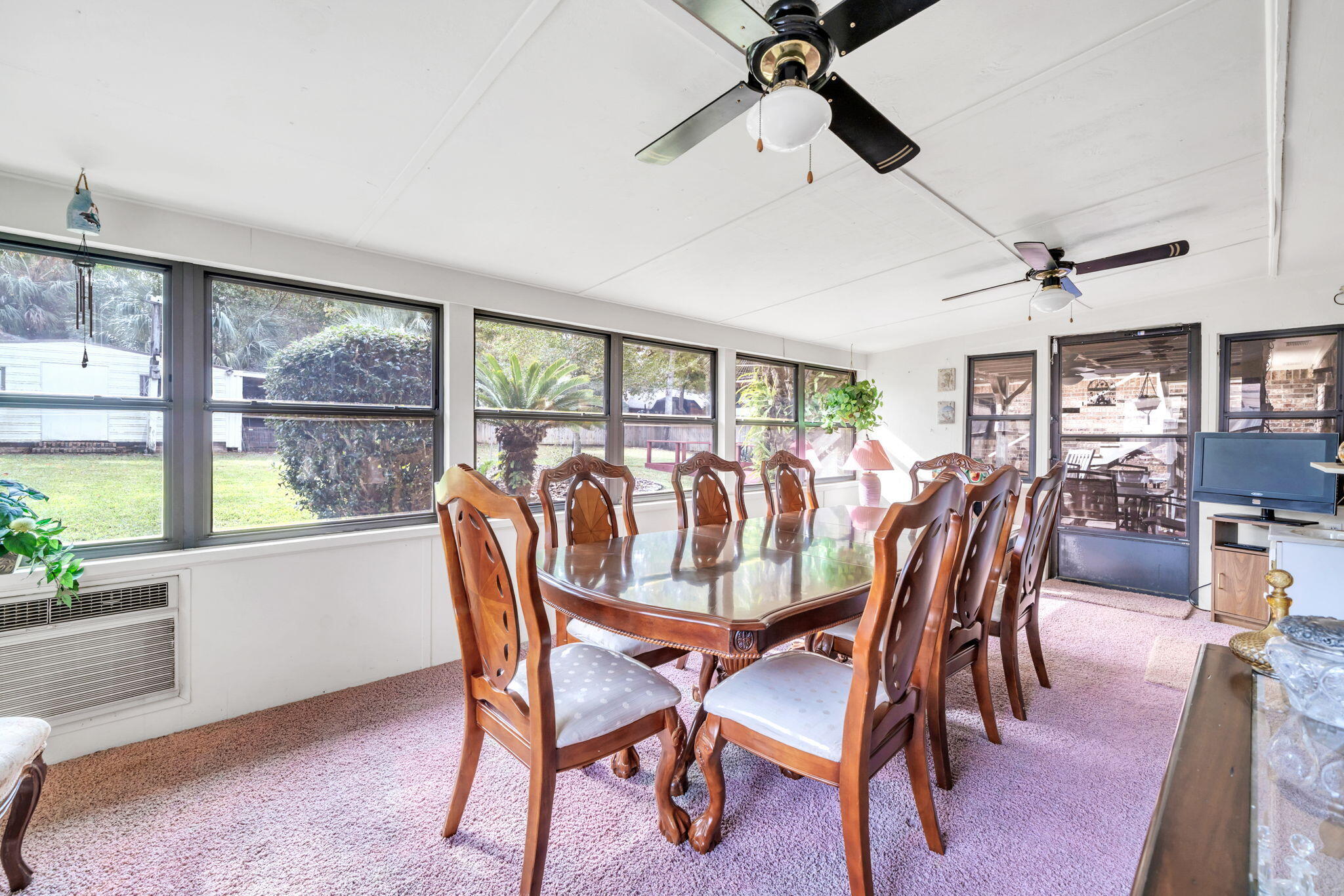 504 Kelly Street Destin, FL 32541 - Photo 21 of 92 a dining room with furniture a flat screen tv and a large window
