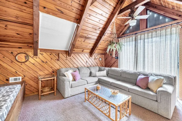 a living room with furniture a rug and a large window