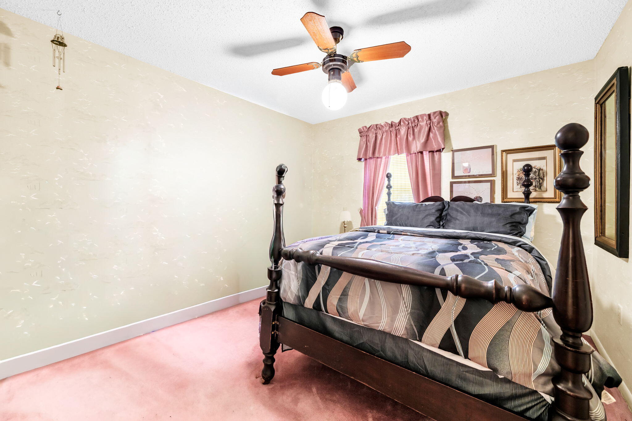504 Kelly Street Destin, FL 32541 - Photo 28 of 92 a bedroom with a bed and a chandelier