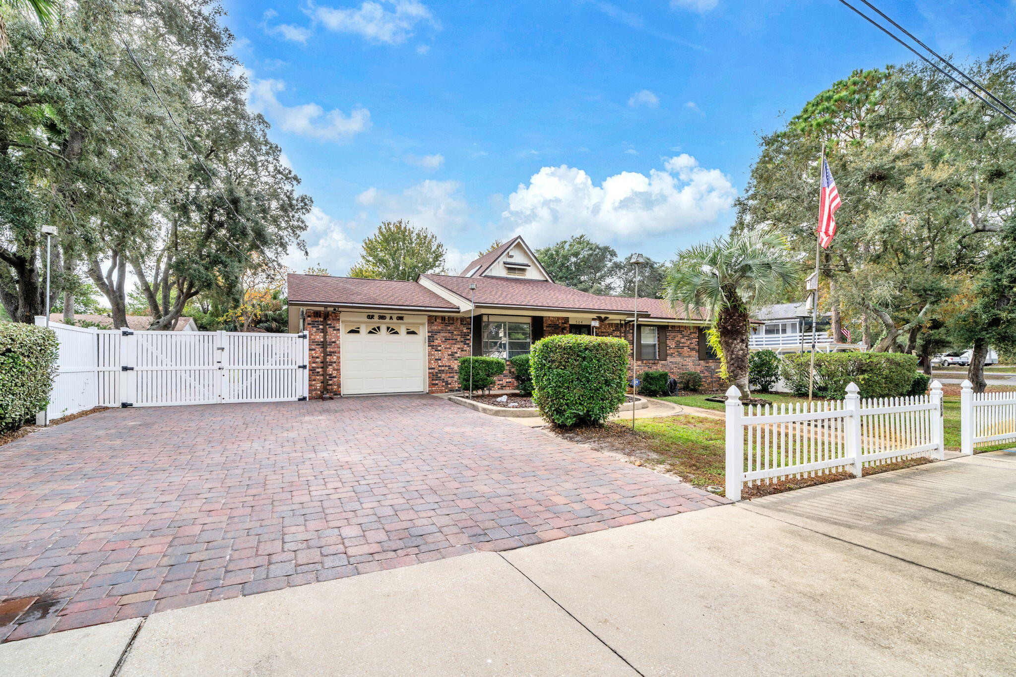 504 Kelly Street Destin, FL 32541 - Photo 4 of 92 a view of a house with a backyard and a garage