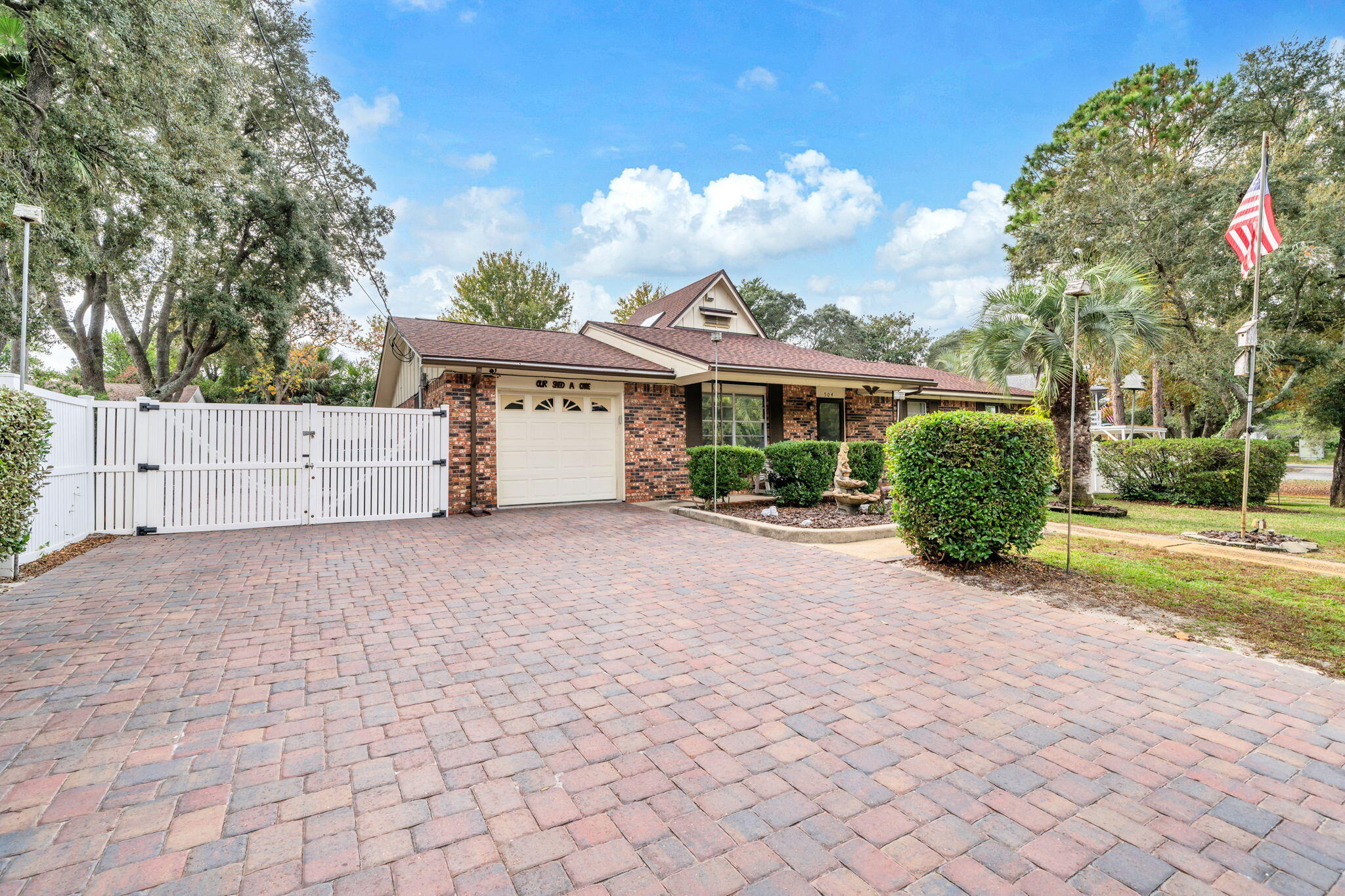 504 Kelly Street Destin, FL 32541 - Photo 6 of 92 a view of a house with a yard and a large tree
